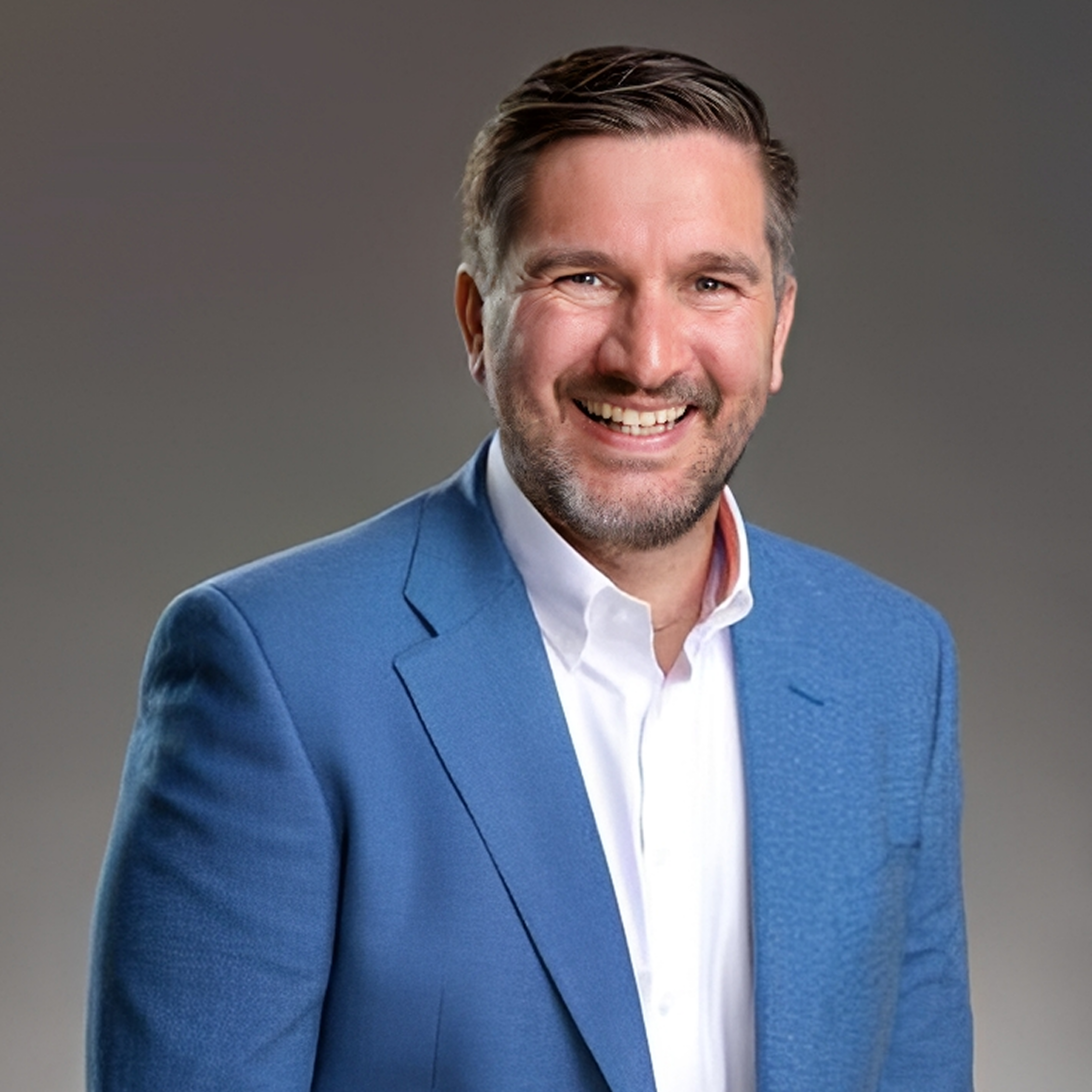 Smiling man in blue suit portrait.