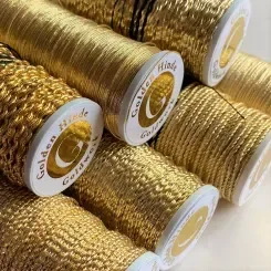 Spools of gold metallic embroidery thread