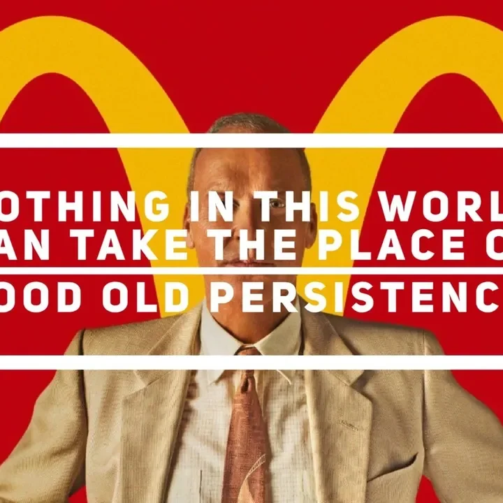 Man in suit before golden arches, persistence quote