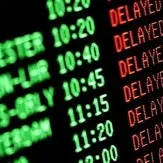 Airport departures board showing multiple flights delayed