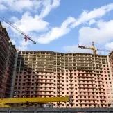 High-rise apartment complex under construction with cranes