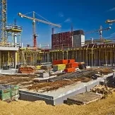 Construction site with cranes and building framework