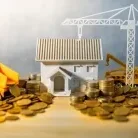 Model house with toy construction vehicles and coins